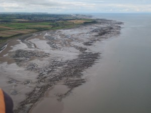 Looking South to Maryport and the wind-turbines at Siddick; the prow of St Bees' head beyond (photo: Ann Lingard)