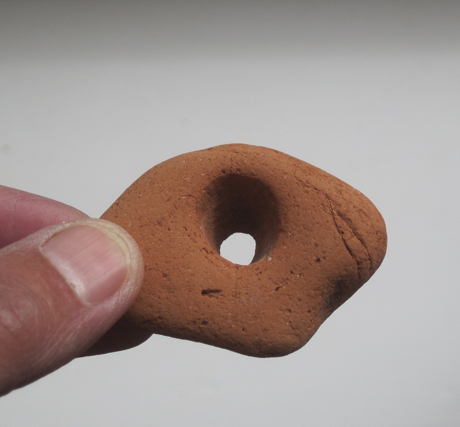 A weight (or a wave-worn piece of brick?)